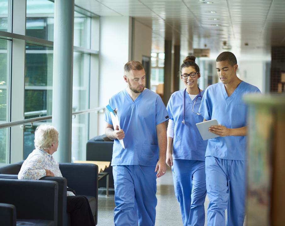 Healthcare staff walking down a corridor