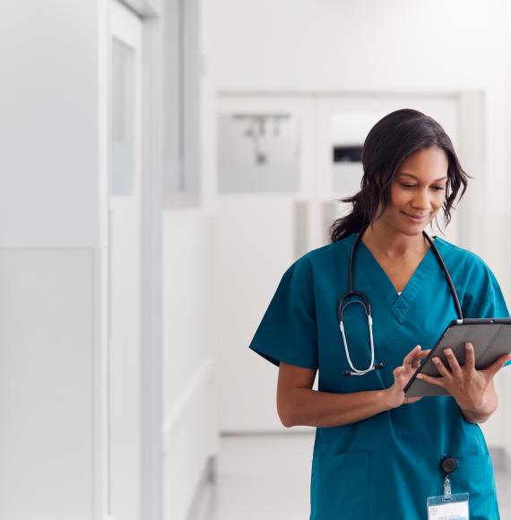 Female health professional using tablet computer