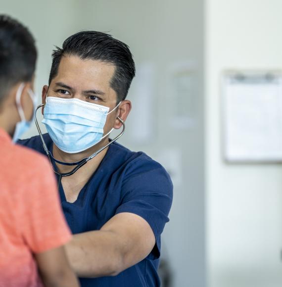 Male doctor examining a young patient