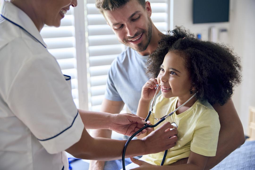 Young girl being treated by a nurse
