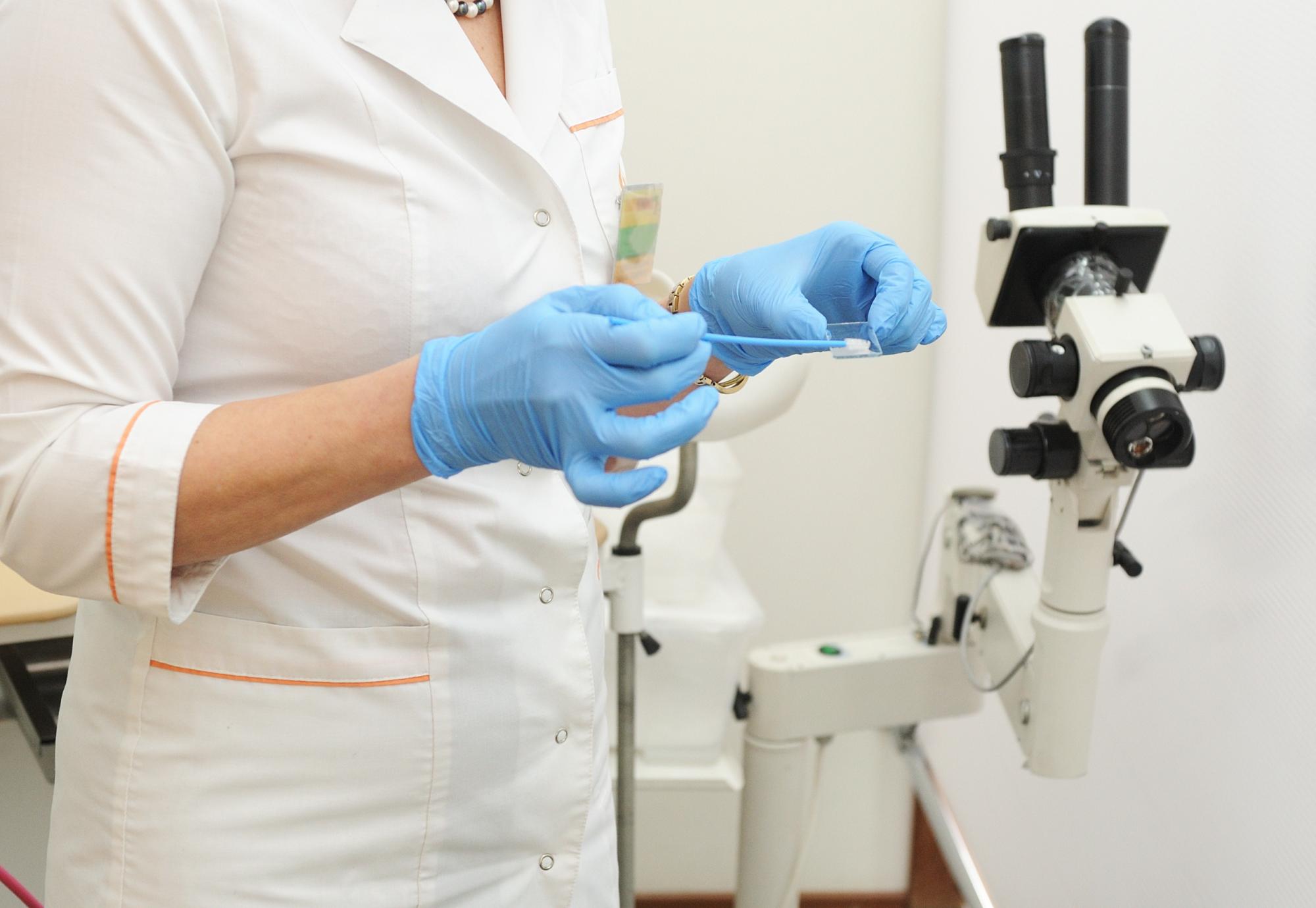 Scientist inspects swab