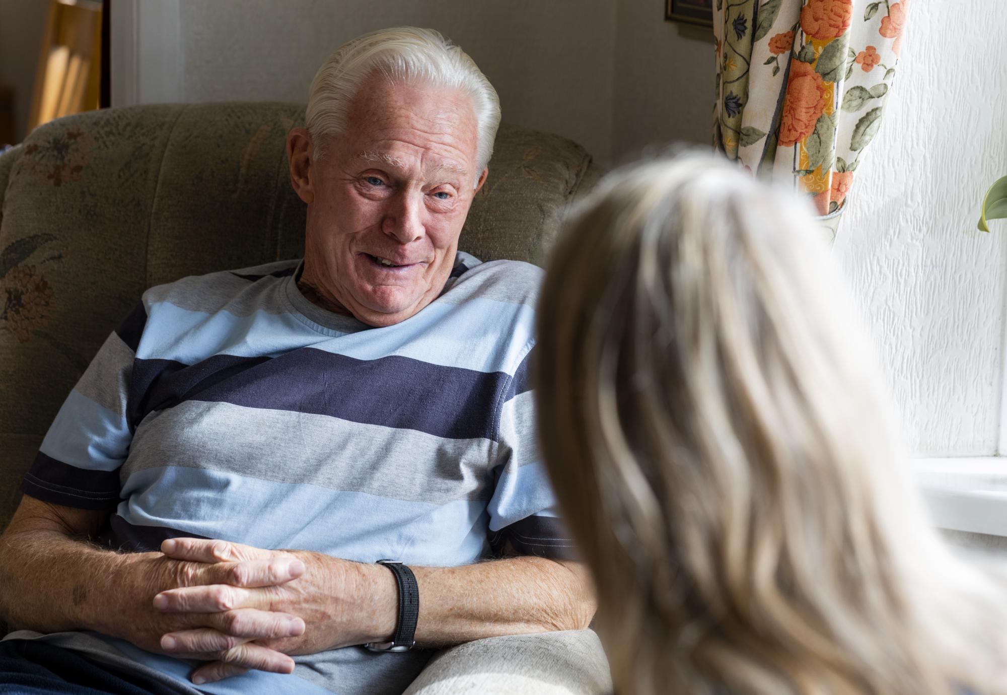 Nurse conversing with a senior patient