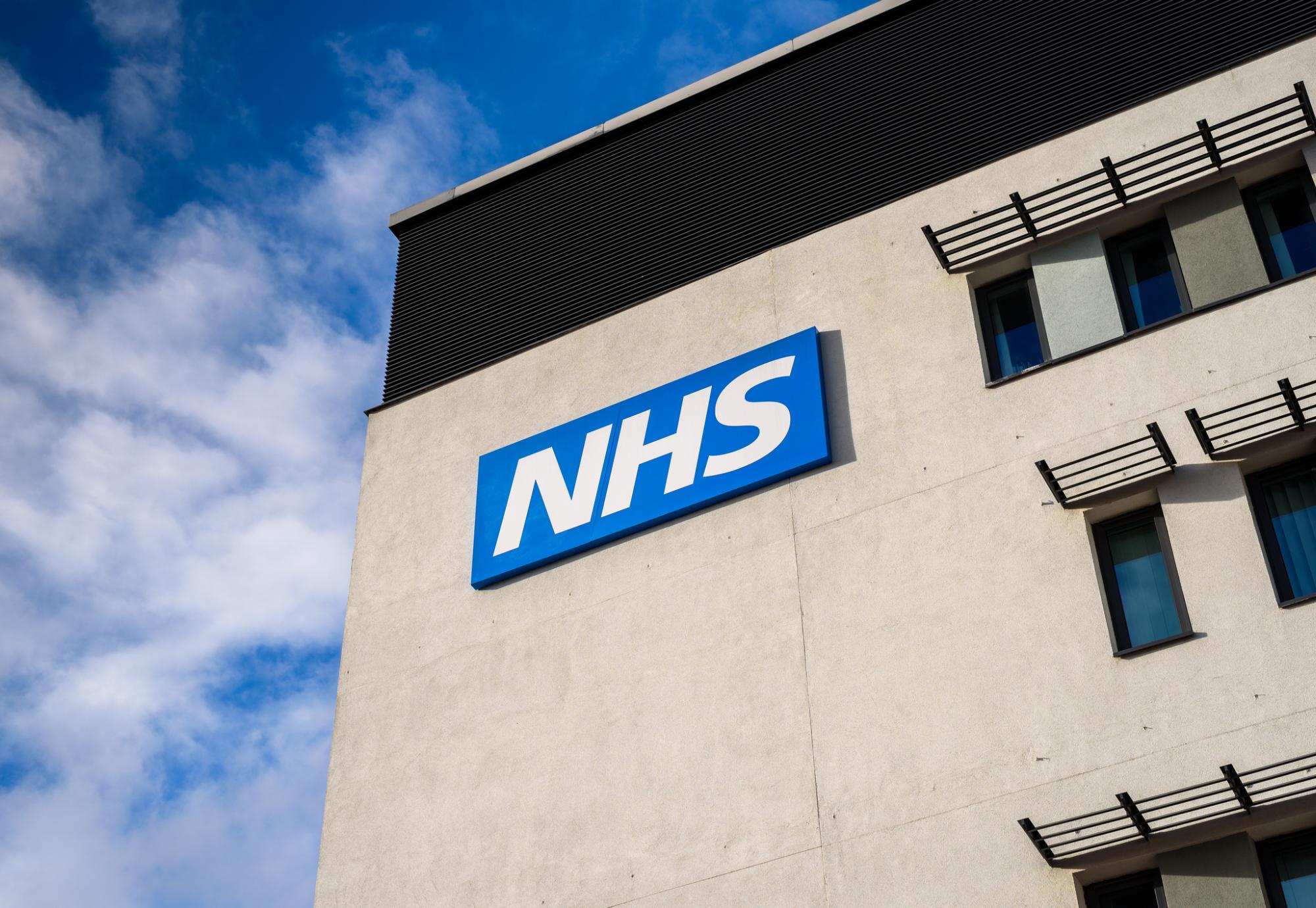 NHS logo on the side of a hospital