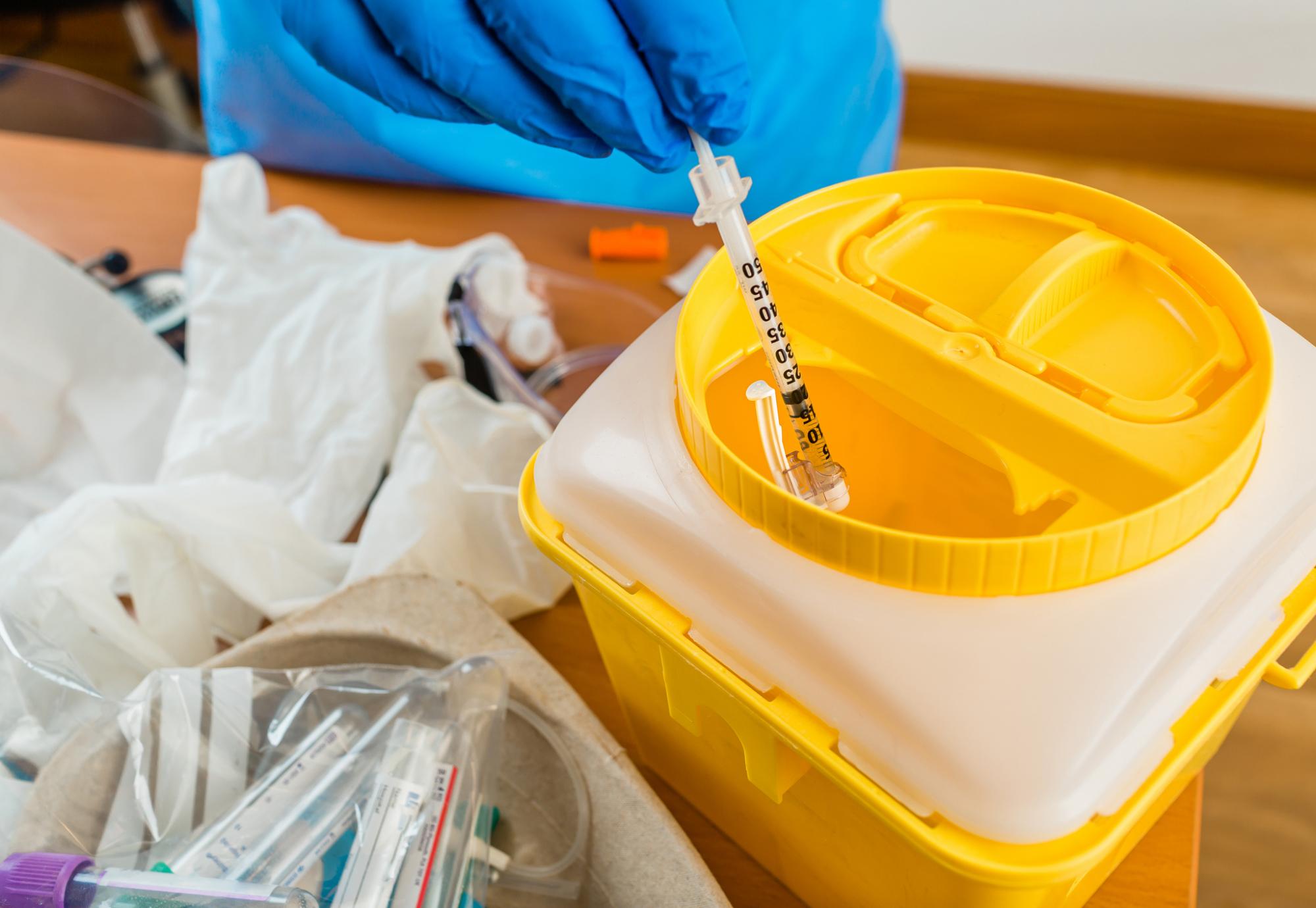 Needle being thrown into a container