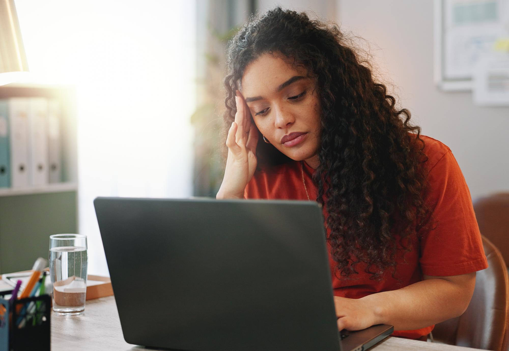 Woman looking at a computer for mental health advice