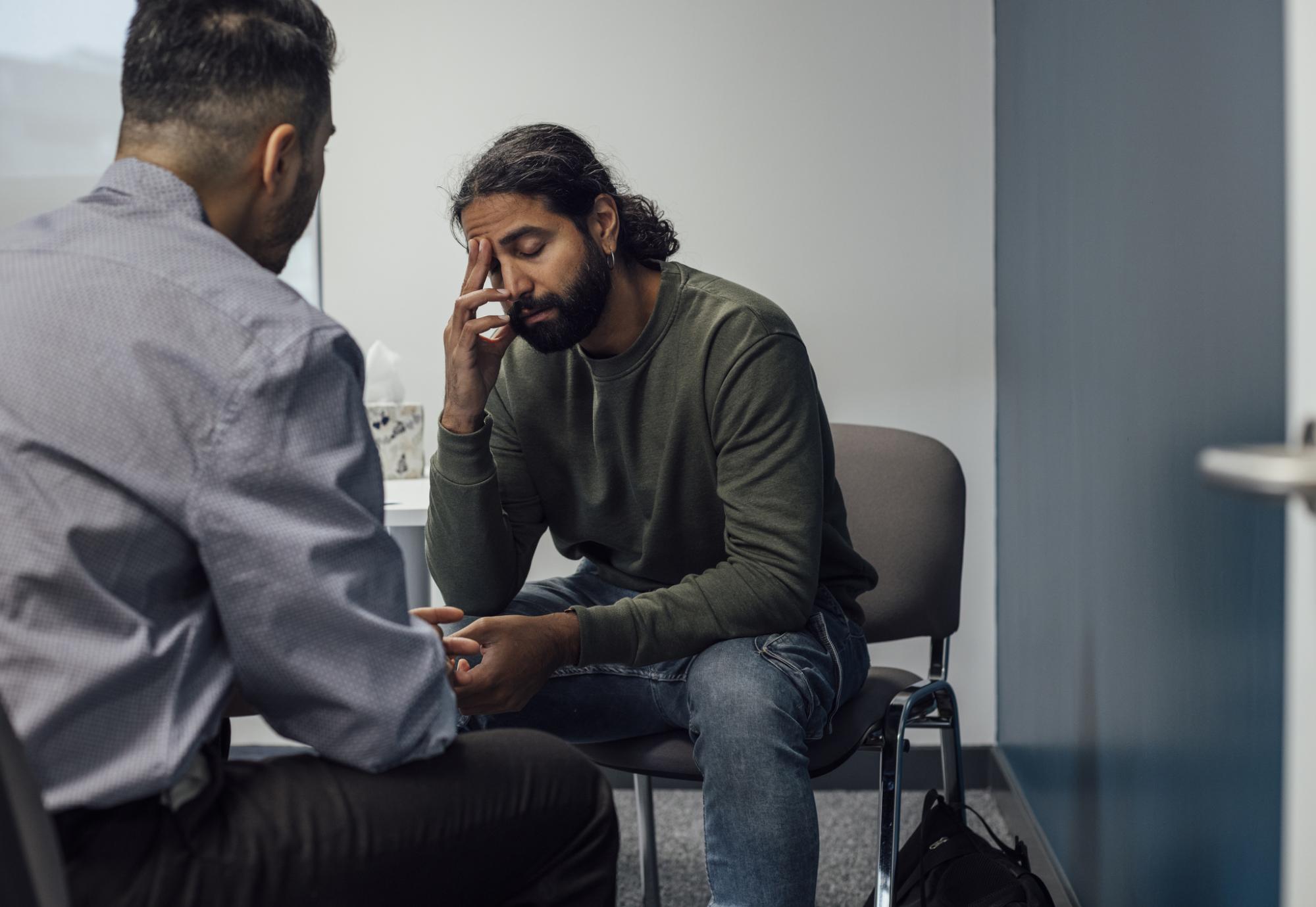 man speaking to a doctor about his mental health