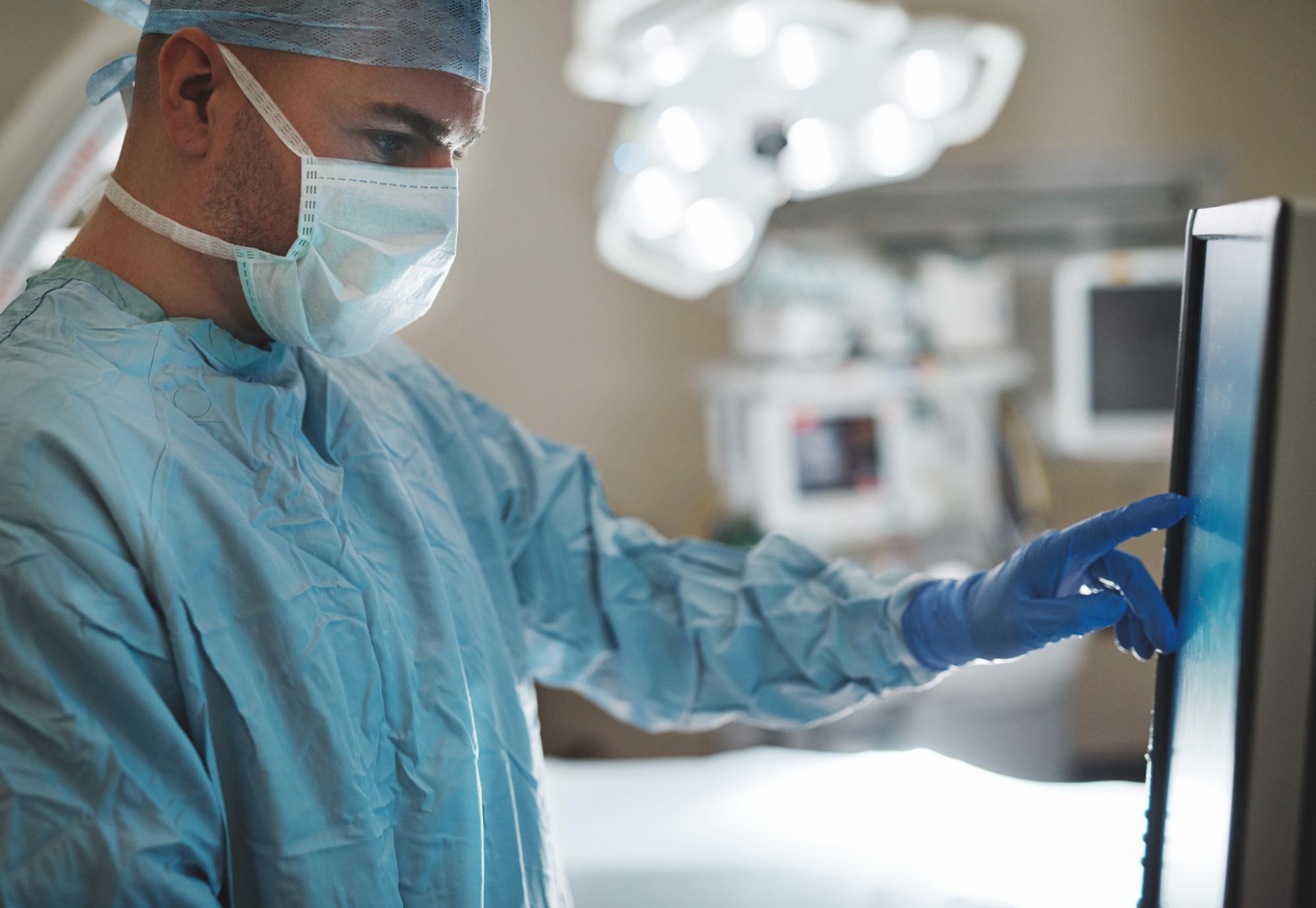 surgeon looking at a monitor in an operating room