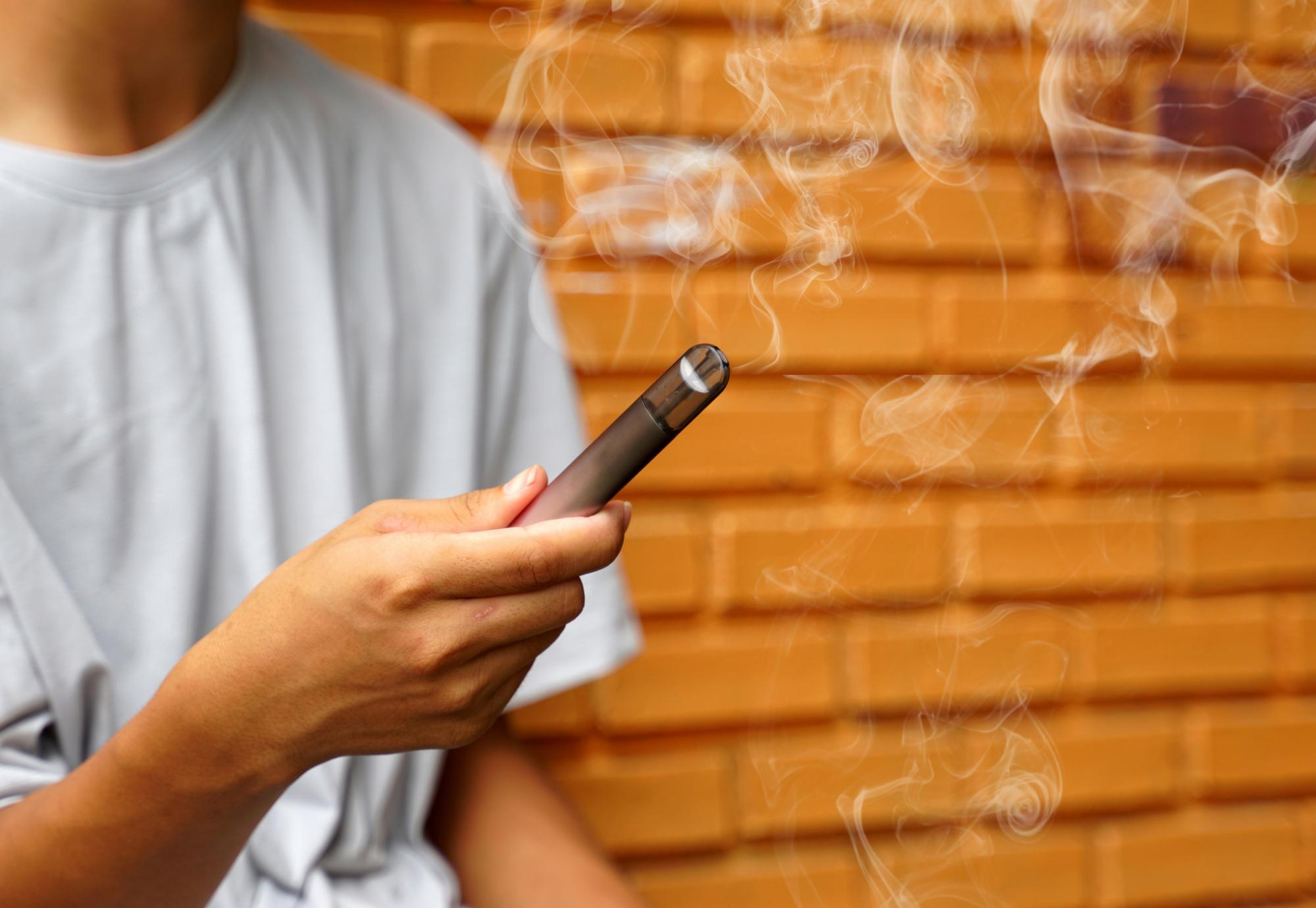 A young person with an e-cigarette