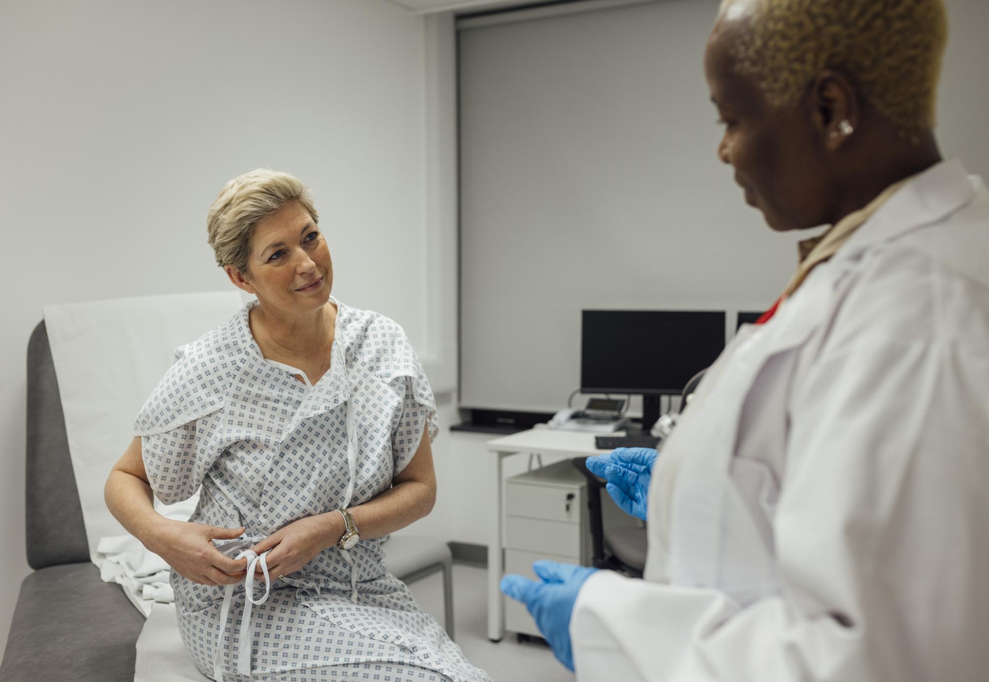 a cancer specialist talking to one of her patients who is undergoing treatment for breast cancer