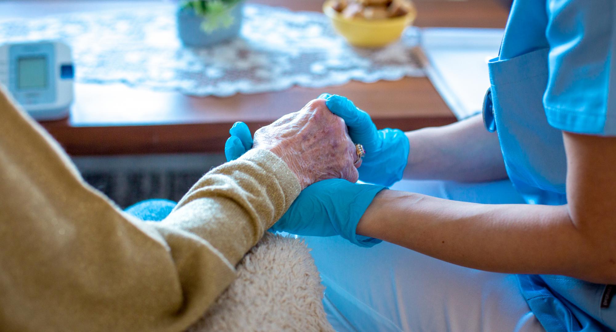 Young female doctor is holding her patient's hand