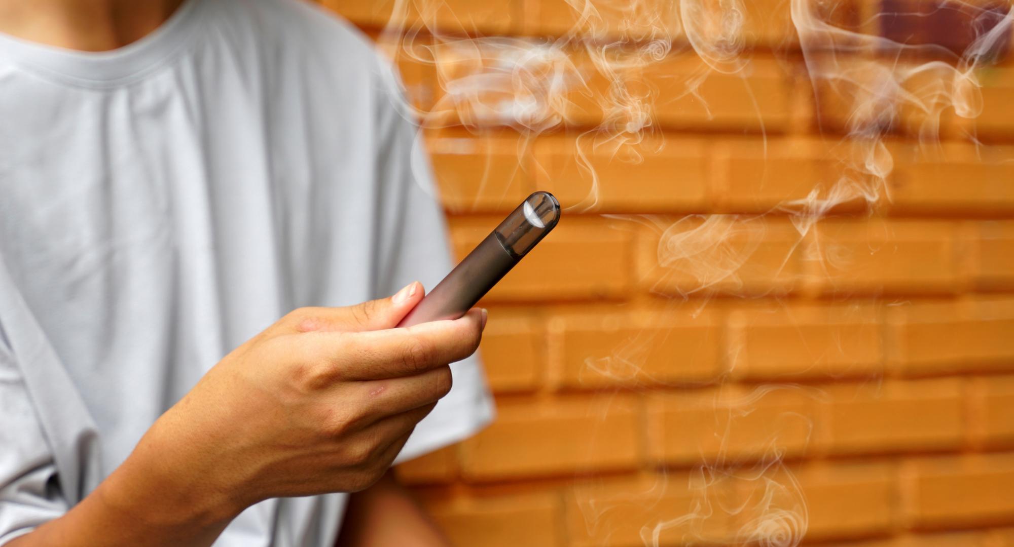 A young person with an e-cigarette