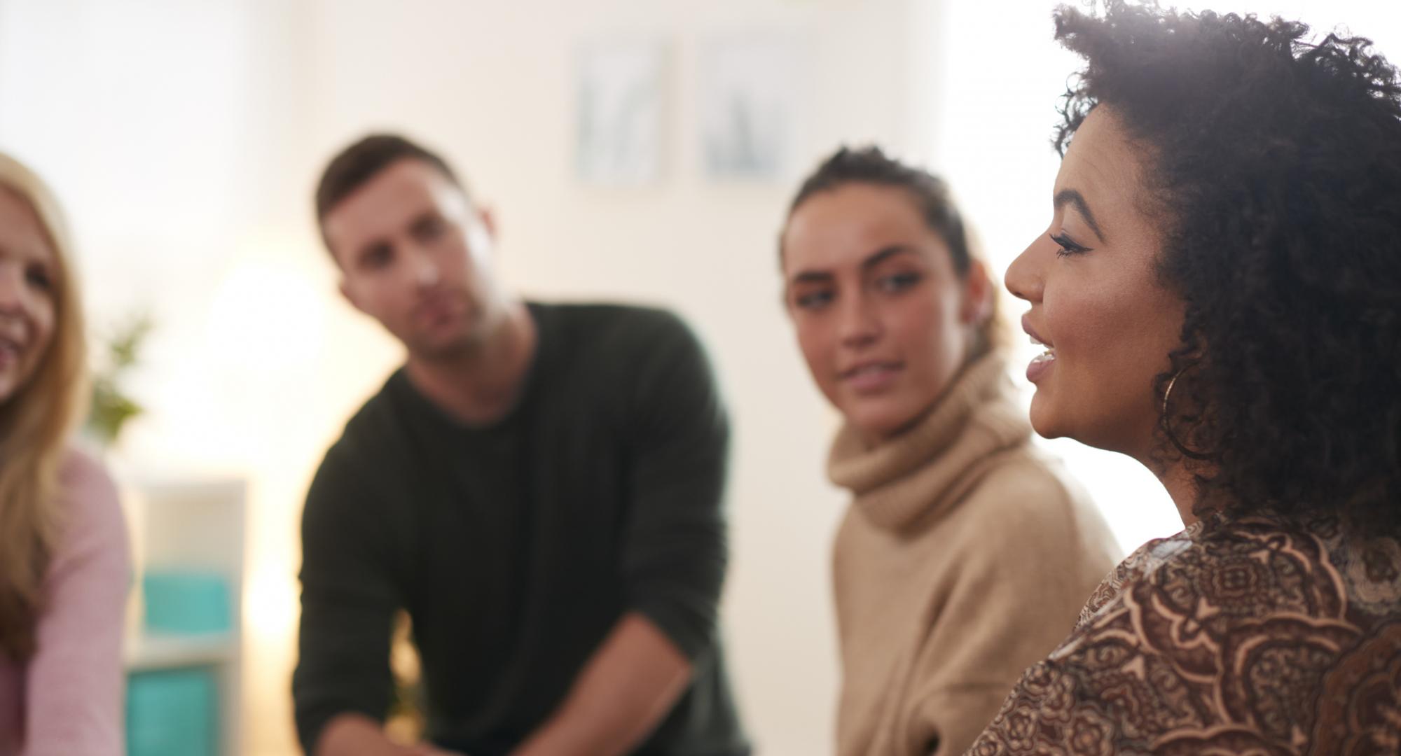 Woman Speaking At Support Group Meeting For Mental Health