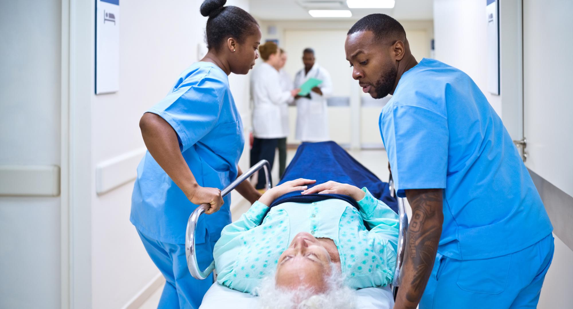 Nurses pushing woman on a hospital bed