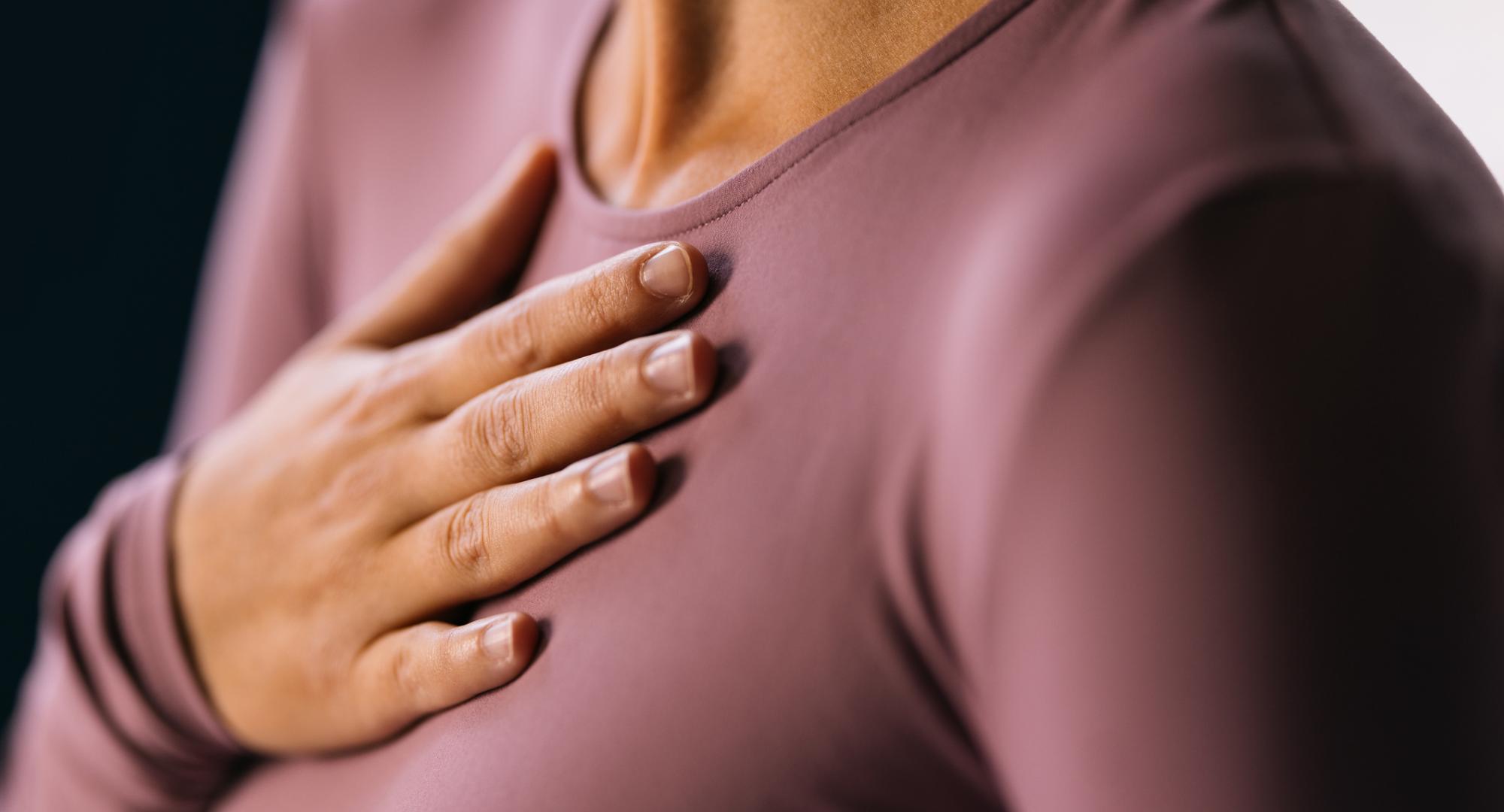 Woman with a hand on her chest