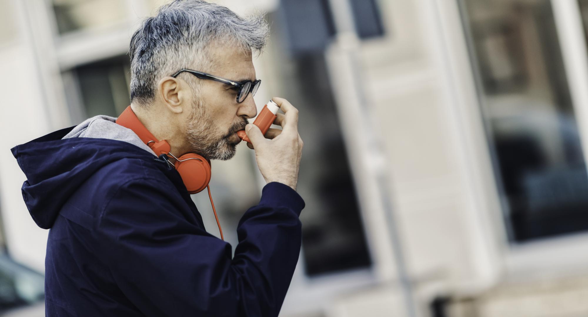 Man using an inhaler