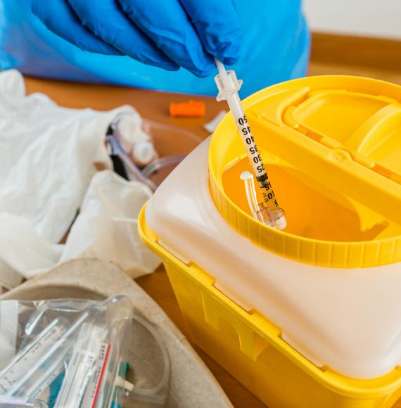 Needle being thrown into a container