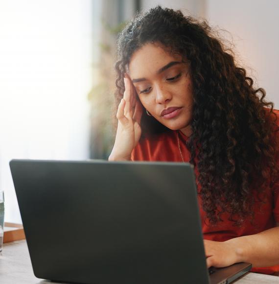 Woman looking at a computer for mental health advice