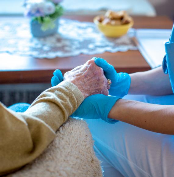 Young female doctor is holding her patient's hand