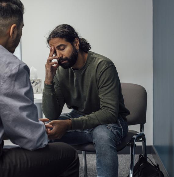 man speaking to a doctor about his mental health