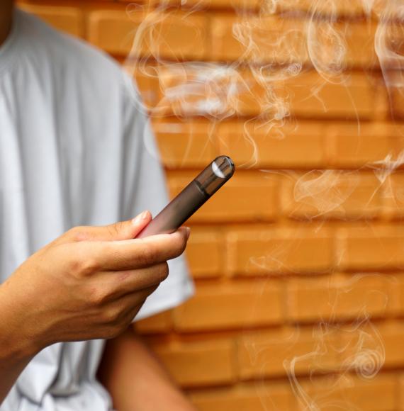 A young person with an e-cigarette