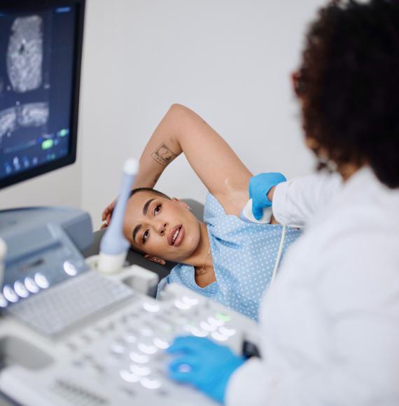 A young woman is doing a breast ultrasound for preventive breast cancer care