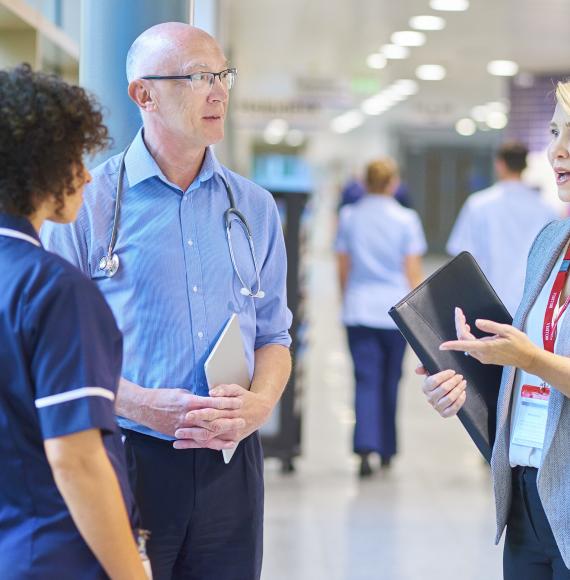 NHS professionals talking in a corridor