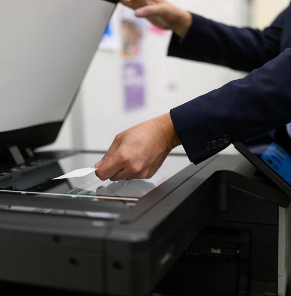 Person placing business card in a scanner