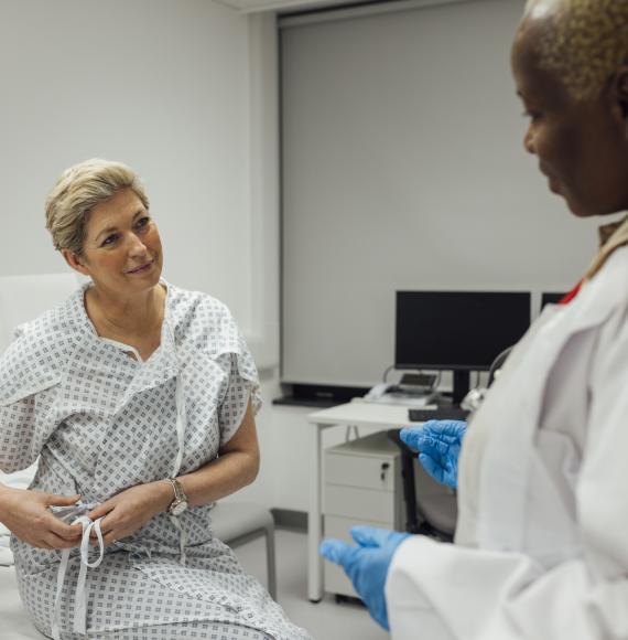 a cancer specialist talking to one of her patients who is undergoing treatment for breast cancer